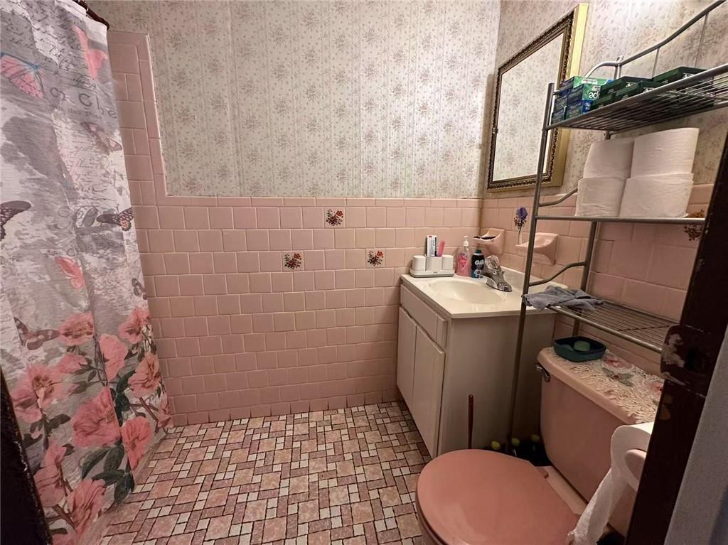 627 50th Street Brooklyn, NY 11220 - Photo 9 of 9 a bathroom with a sink toilet and shower