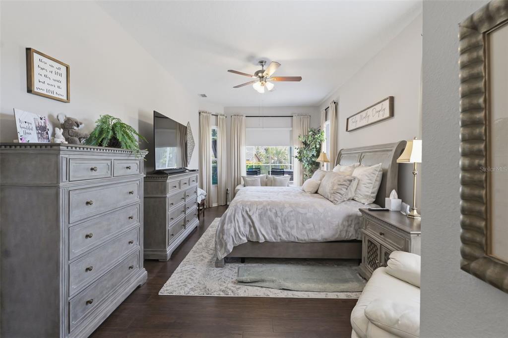 14126 Andrew Scott Road Spring Hill, FL 34609 - Photo 17 of 29 a spacious bedroom with a bed and ceiling fan