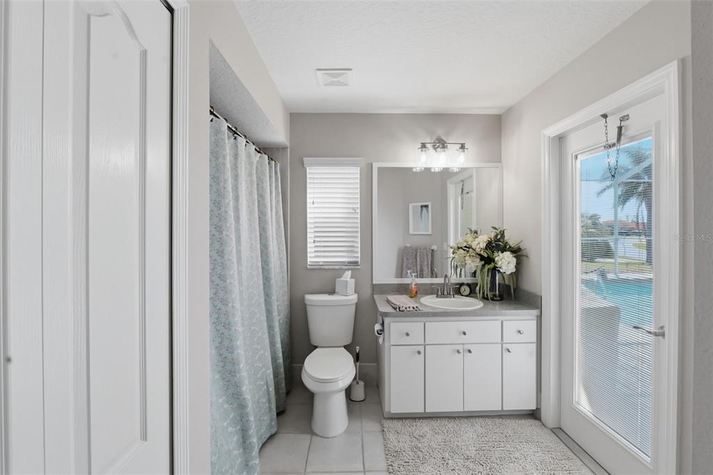 14126 Andrew Scott Road Spring Hill, FL 34609 - Photo 21 of 29 a spacious bathroom with a toilet sink and mirror