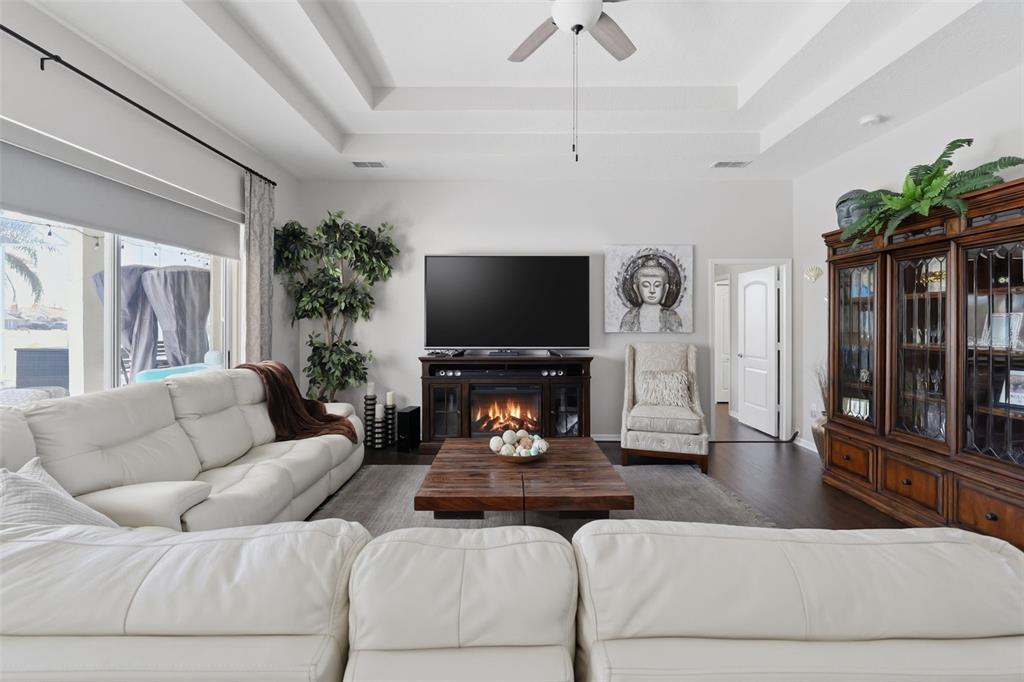 14126 Andrew Scott Road Spring Hill, FL 34609 - Photo 7 of 29 a living room with furniture a flat screen tv and a chandelier