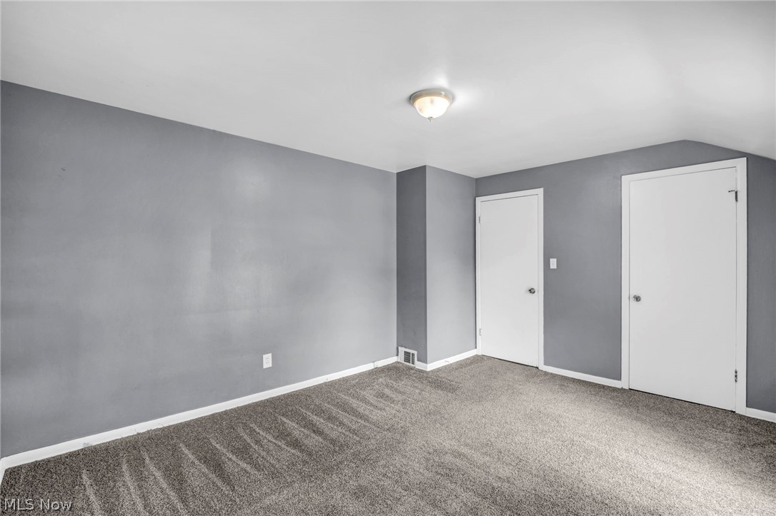 2313 North Taylor Road Cleveland Heights, OH 44112 - Photo 13 of 32 Spacious room featuring gray wall paint, contrasting white trim, and a contemporary flush-mount ceiling light