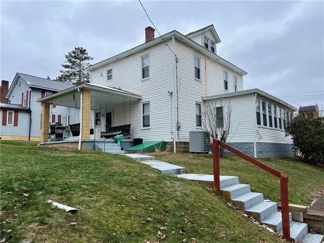 a front view of house with a garden and patio