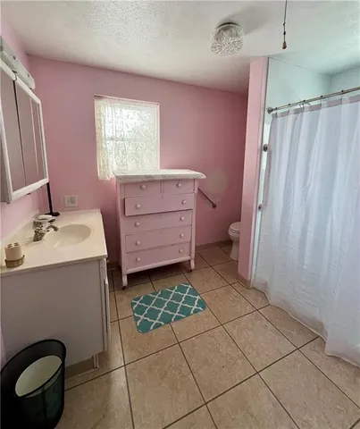 a bathroom with a sink a mirror and a shower
