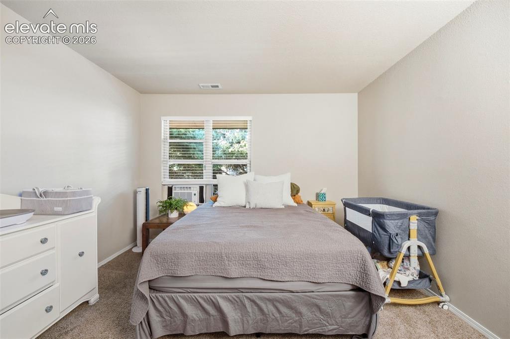 4357 Hunting Meadows Circle Colorado Springs, CO 80916 - Photo 8 of 20 a bedroom with a bed and a window