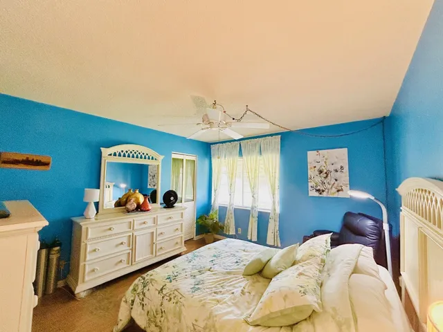 a bedroom with furniture and a large window