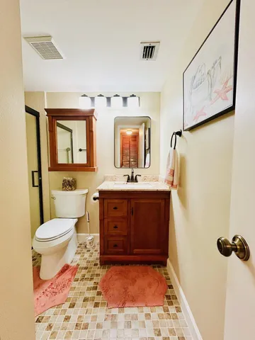 a bathroom with a sink a toilet and mirror