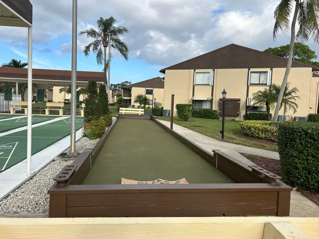 a view of swimming pool with a lawn chairs under an umbrella