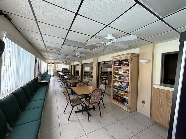 a dining room with furniture and a book shelf