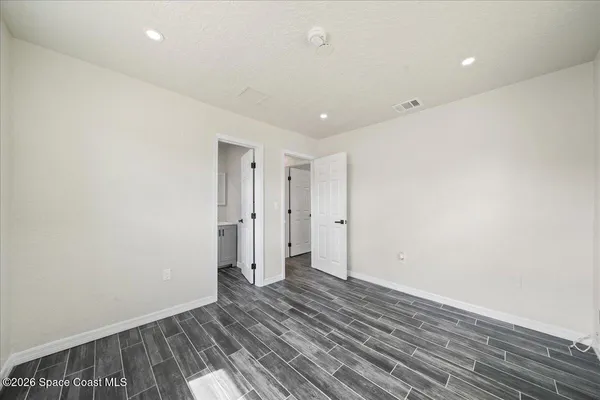 a view of hallway with wooden floor