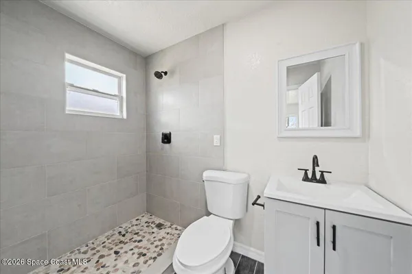 a white toilet sitting next to a bathroom sink