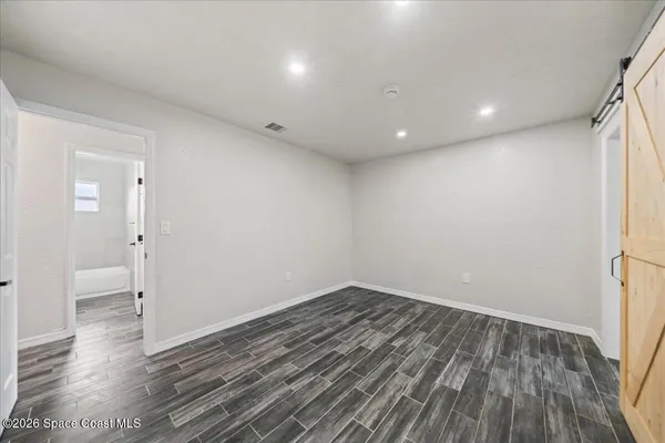 a view of wooden floor and windows in an empty room