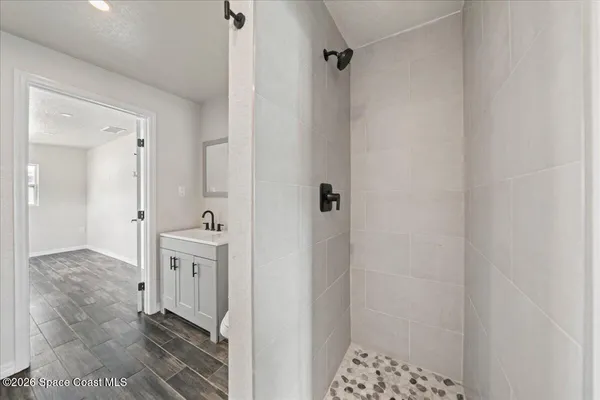 a bathroom with a shower and a sink