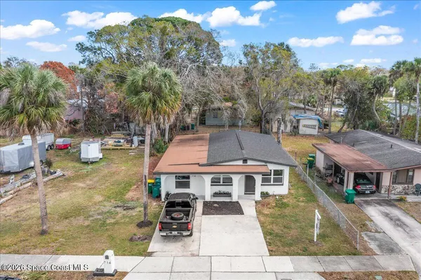 a aerial view of a house with swimming pool and furniture