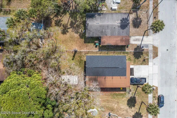 an aerial view of a house with a yard