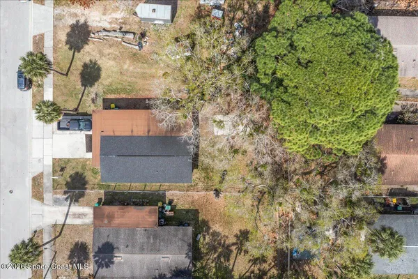 an aerial view of residential houses with outdoor space