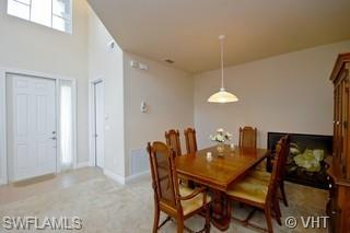 12643 Biscayne Court Naples, FL 34105 - Photo 4 of 8 a dining room with furniture and window