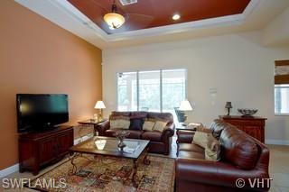 12643 Biscayne Court Naples, FL 34105 - Photo 5 of 8 a living room with furniture and a flat screen tv