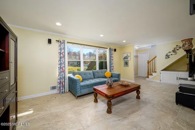 a dining room with furniture a chandelier and window