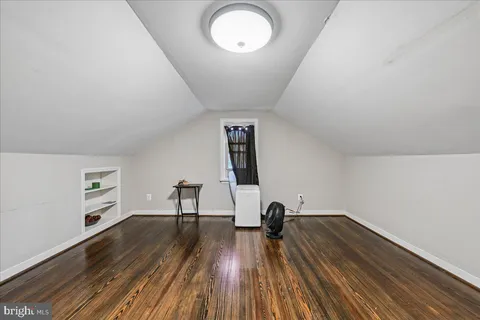 a view of a room with wooden floor and window