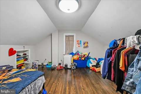 a view of a play room with toys and wooden floor