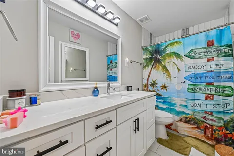 a bathroom with a sink mirror and vanity