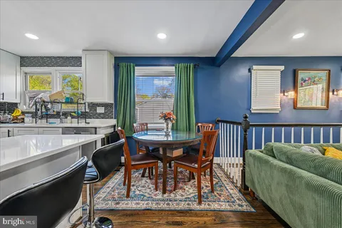 a dining room with furniture a rug and a large window