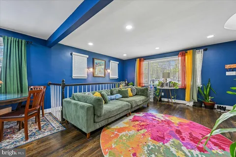 a living room with furniture a rug and a large window