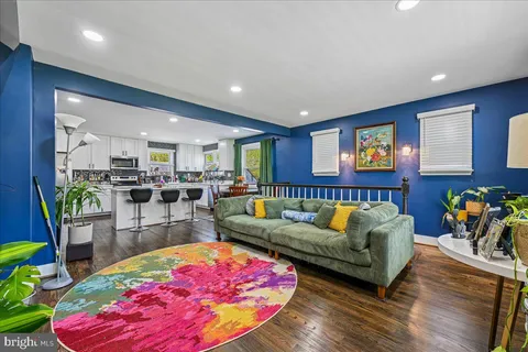 a living room with furniture and kitchen view