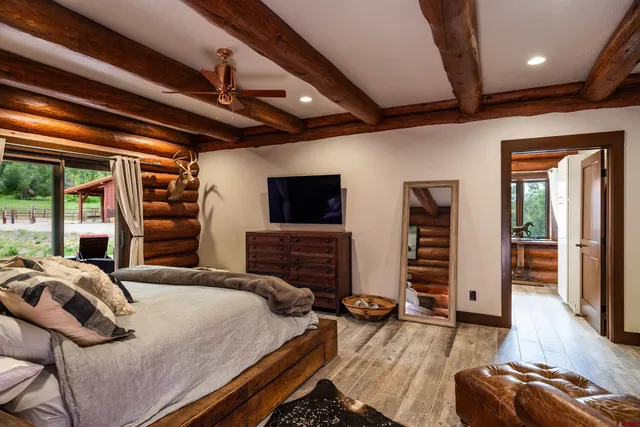 a bedroom with furniture and a flat screen tv