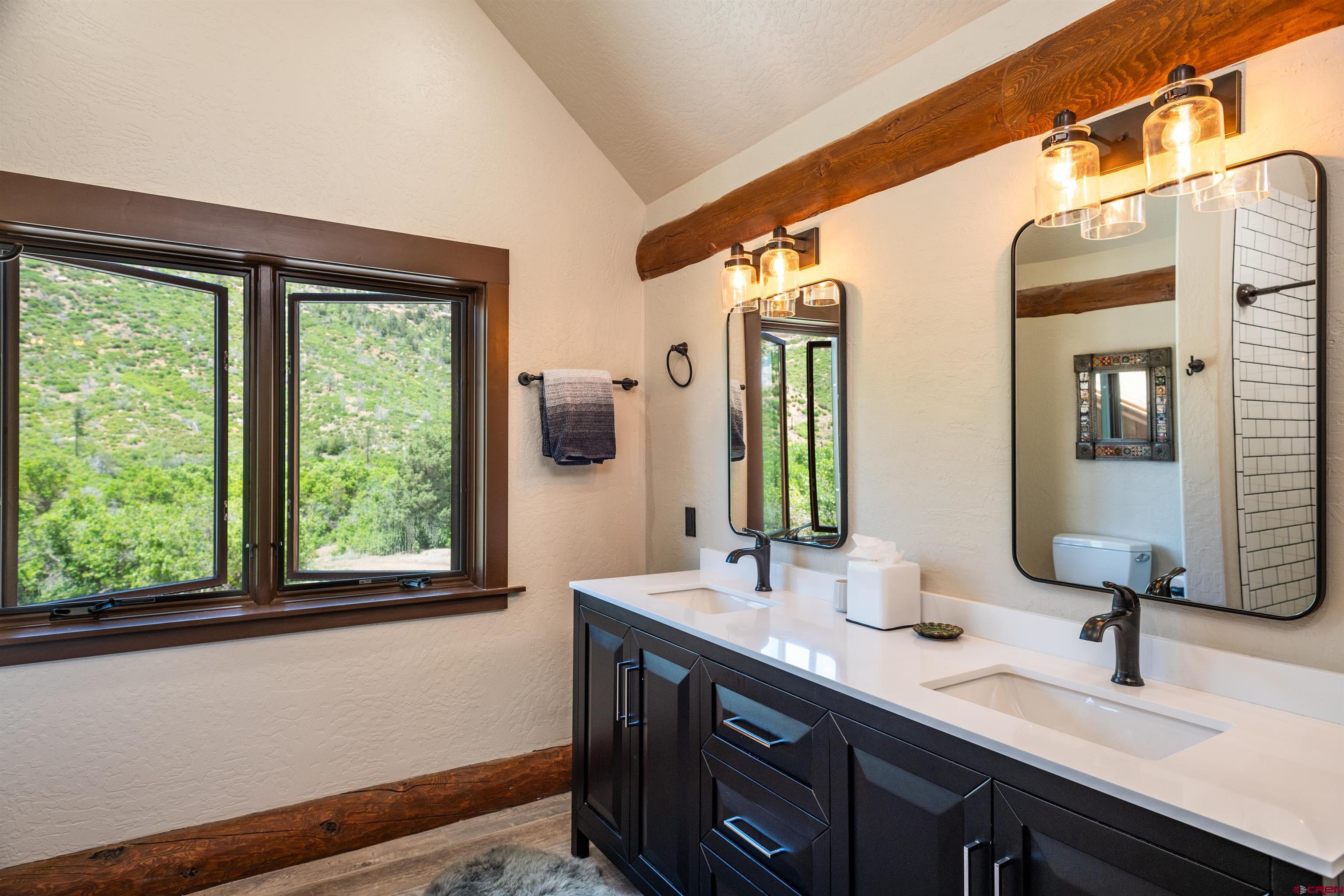 6590 Road 46 Mancos, CO 81328 - Photo 19 of 35 a bathroom with a double vanity sink and a mirror
