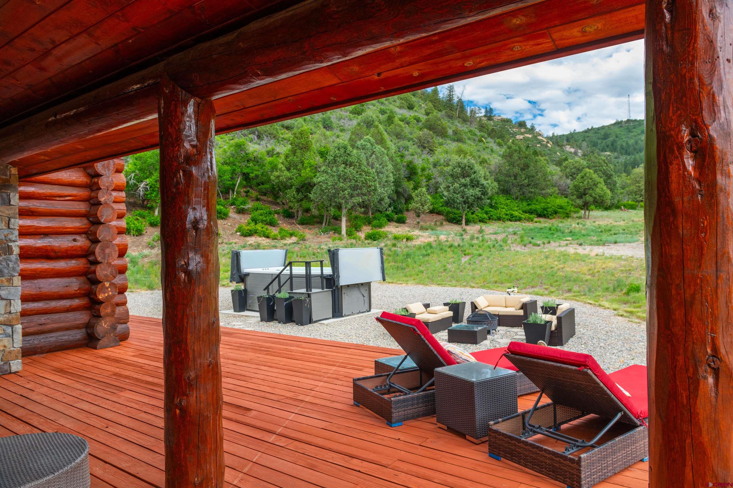 6590 Road 46 Mancos, CO 81328 - Photo 24 of 35 a view of a patio with lawn chairs next to a yard