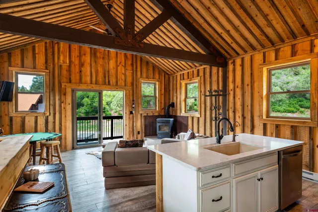 a living room with furniture a wooden floor and next to a window