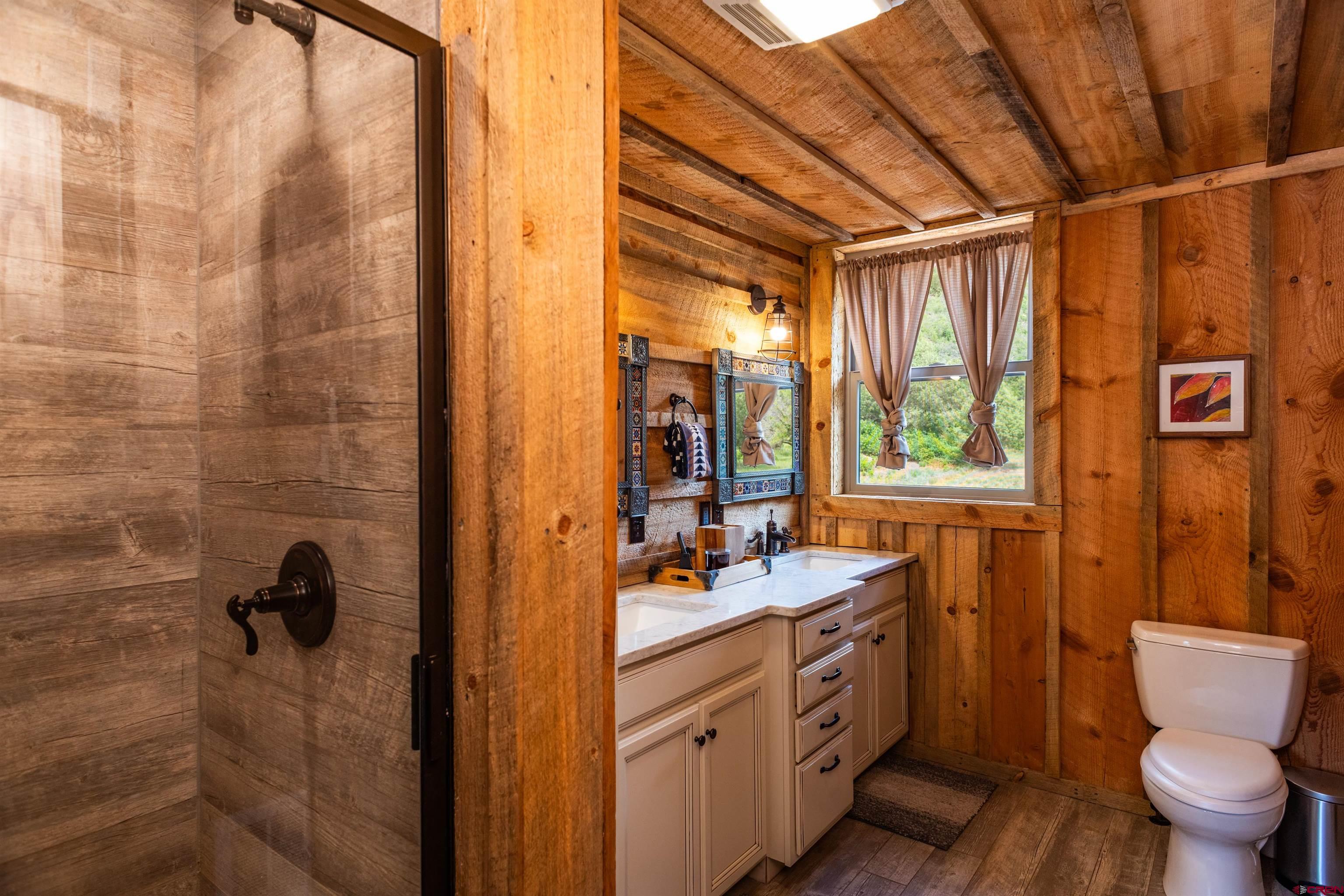 6590 Road 46 Mancos, CO 81328 - Photo 30 of 35 a bathroom with a double vanity sink toilet and shower