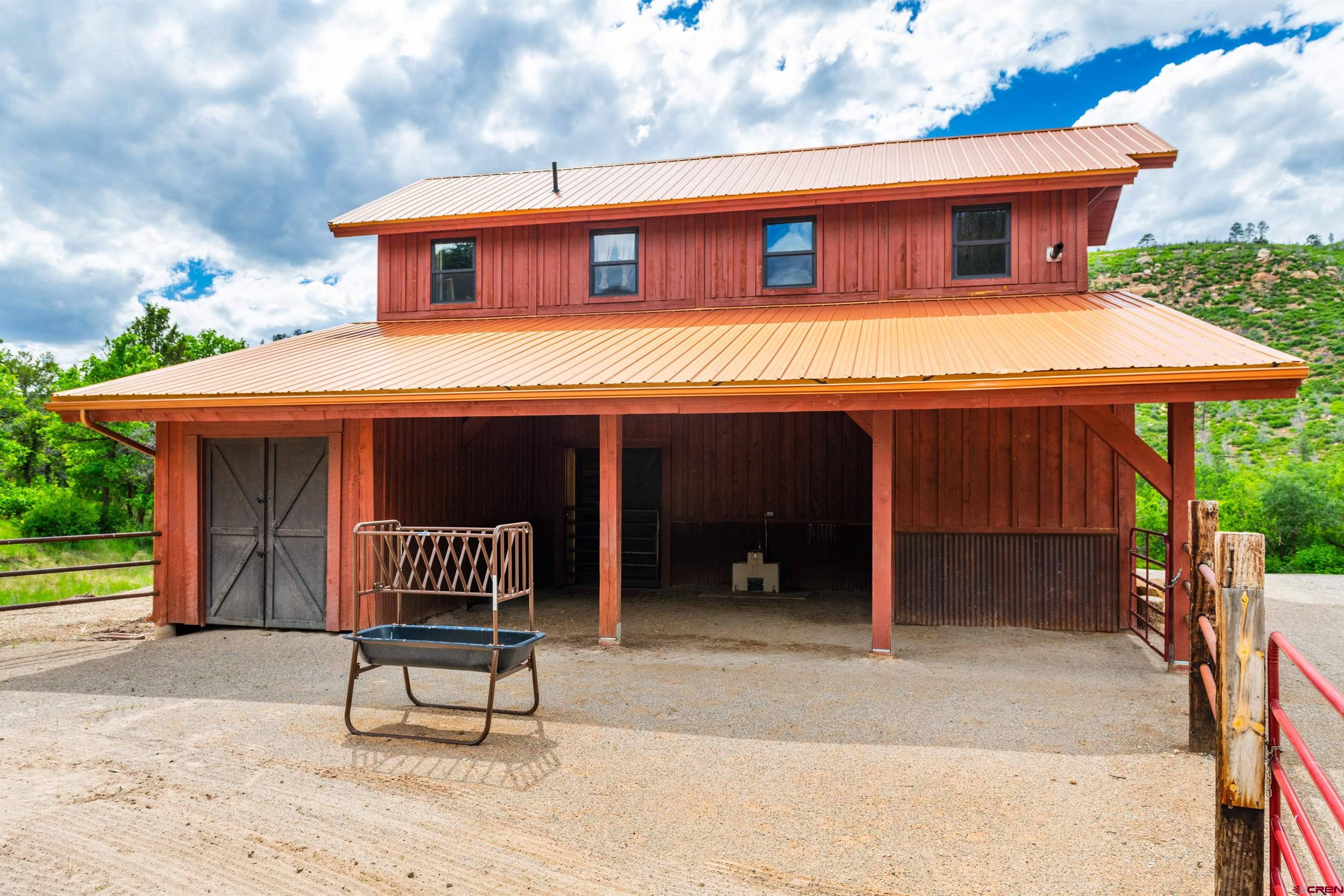 6590 Road 46 Mancos, CO 81328 - Photo 31 of 35 a front view of a house with a yard and table and chair