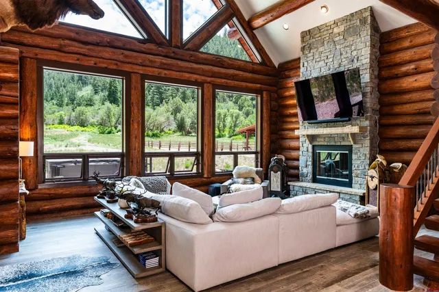 a living room with furniture fireplace and flat screen tv