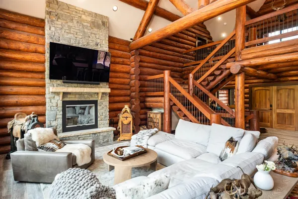 a living room with furniture a flat screen tv and a fireplace