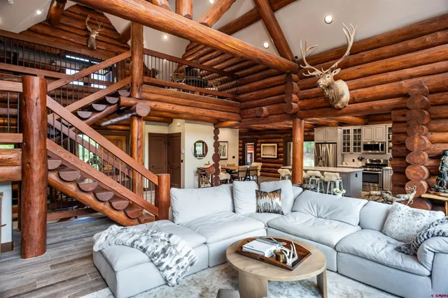 a living room with furniture and wooden floors