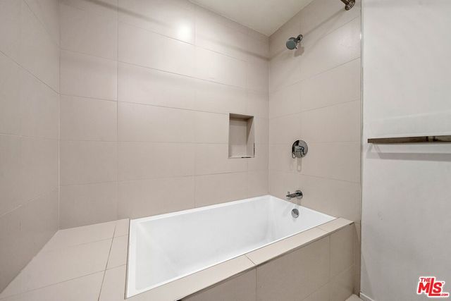 a bathroom with a tub and shower