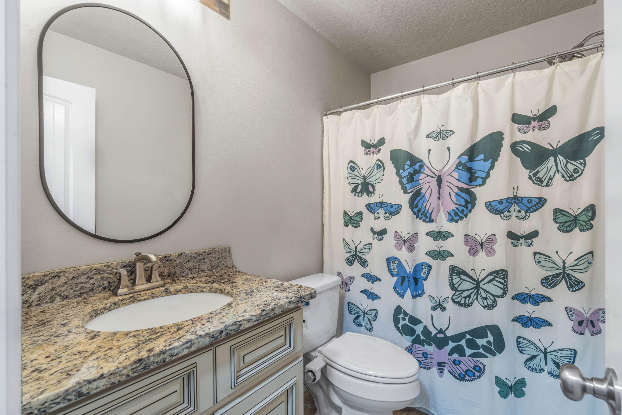 4746 Chanson Crossing Crestview, FL 32539 - Photo 10 of 21 a bathroom with a granite countertop sink a toilet and a mirror
