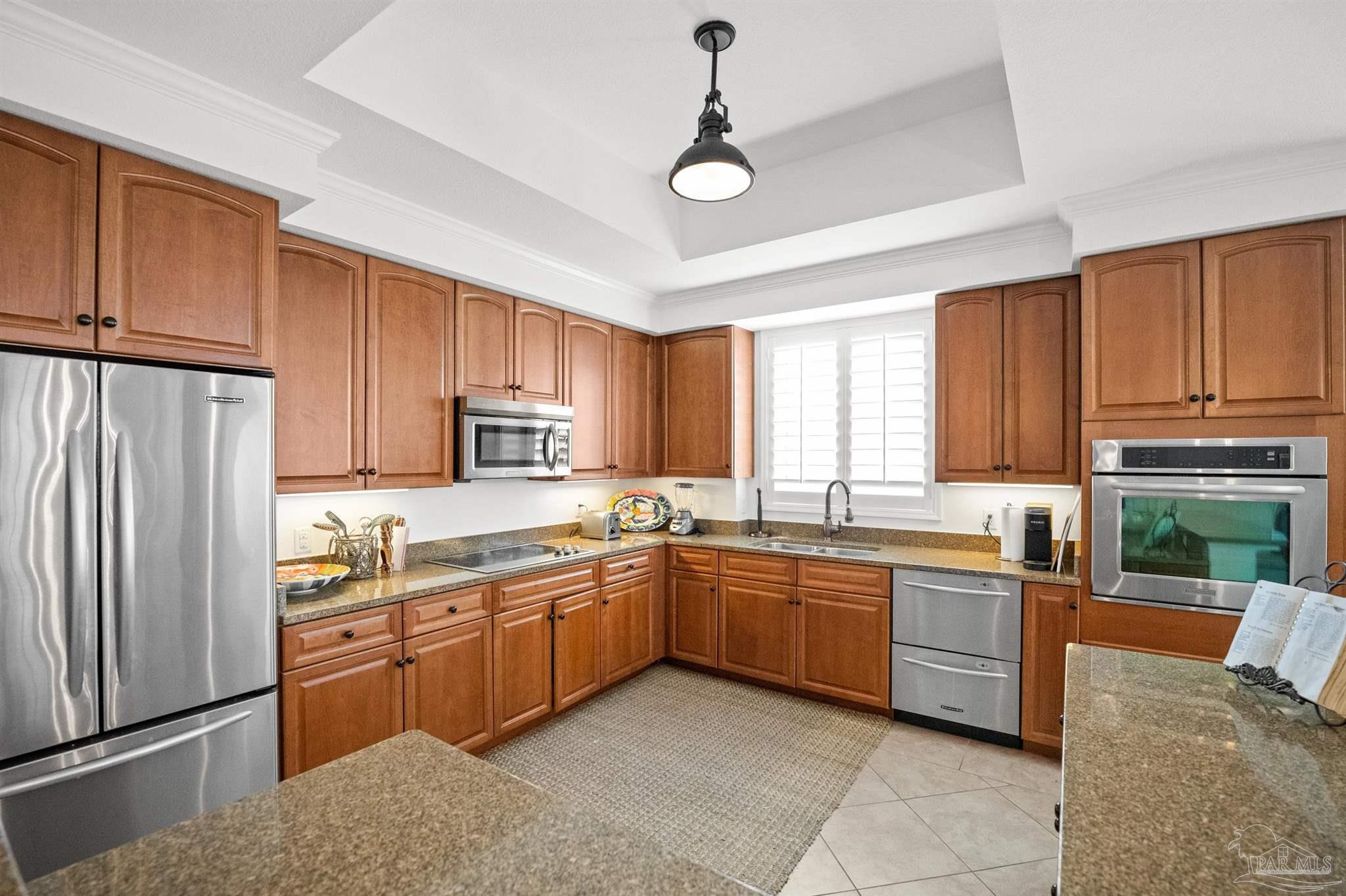 14500 River Road, Unit 101 Pensacola, FL 32507 - Photo 25 of 61 a kitchen with stainless steel appliances granite countertop a refrigerator sink and cabinets