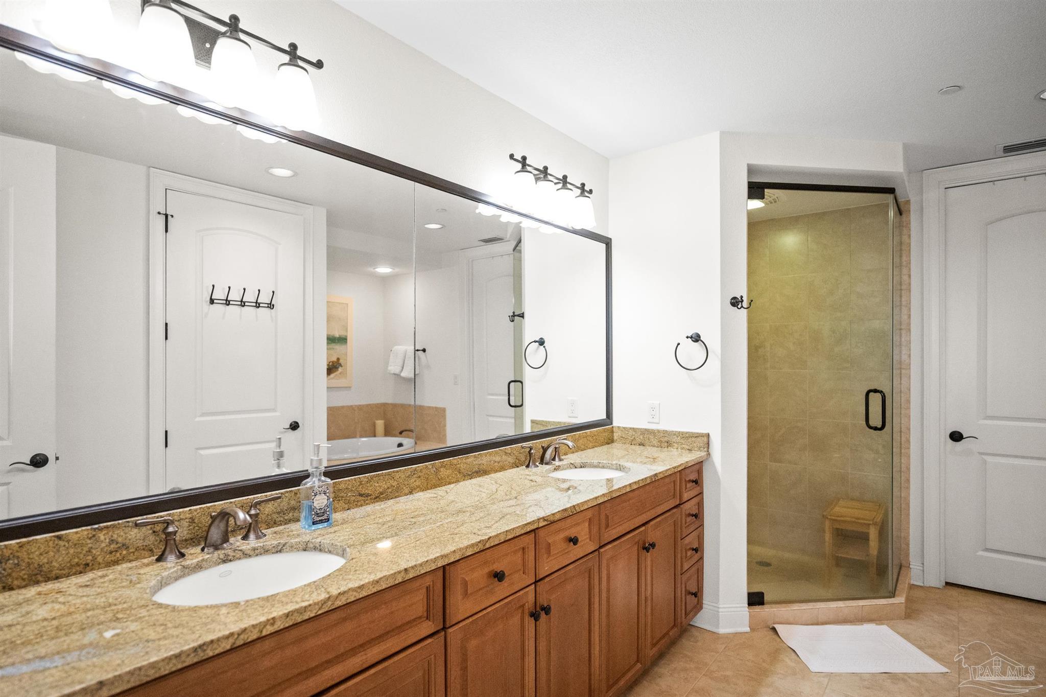 14500 River Road, Unit 101 Pensacola, FL 32507 - Photo 32 of 61 a bathroom with a granite countertop double vanity sink and a mirror
