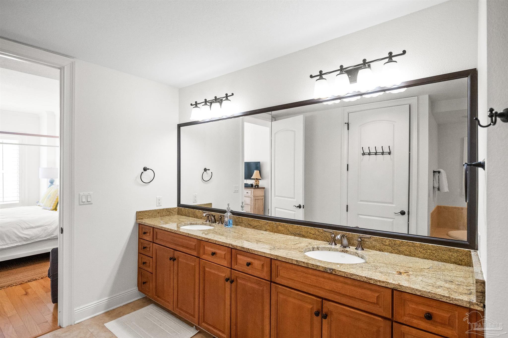 14500 River Road, Unit 101 Pensacola, FL 32507 - Photo 36 of 61 a bathroom with a granite countertop sink mirror and double