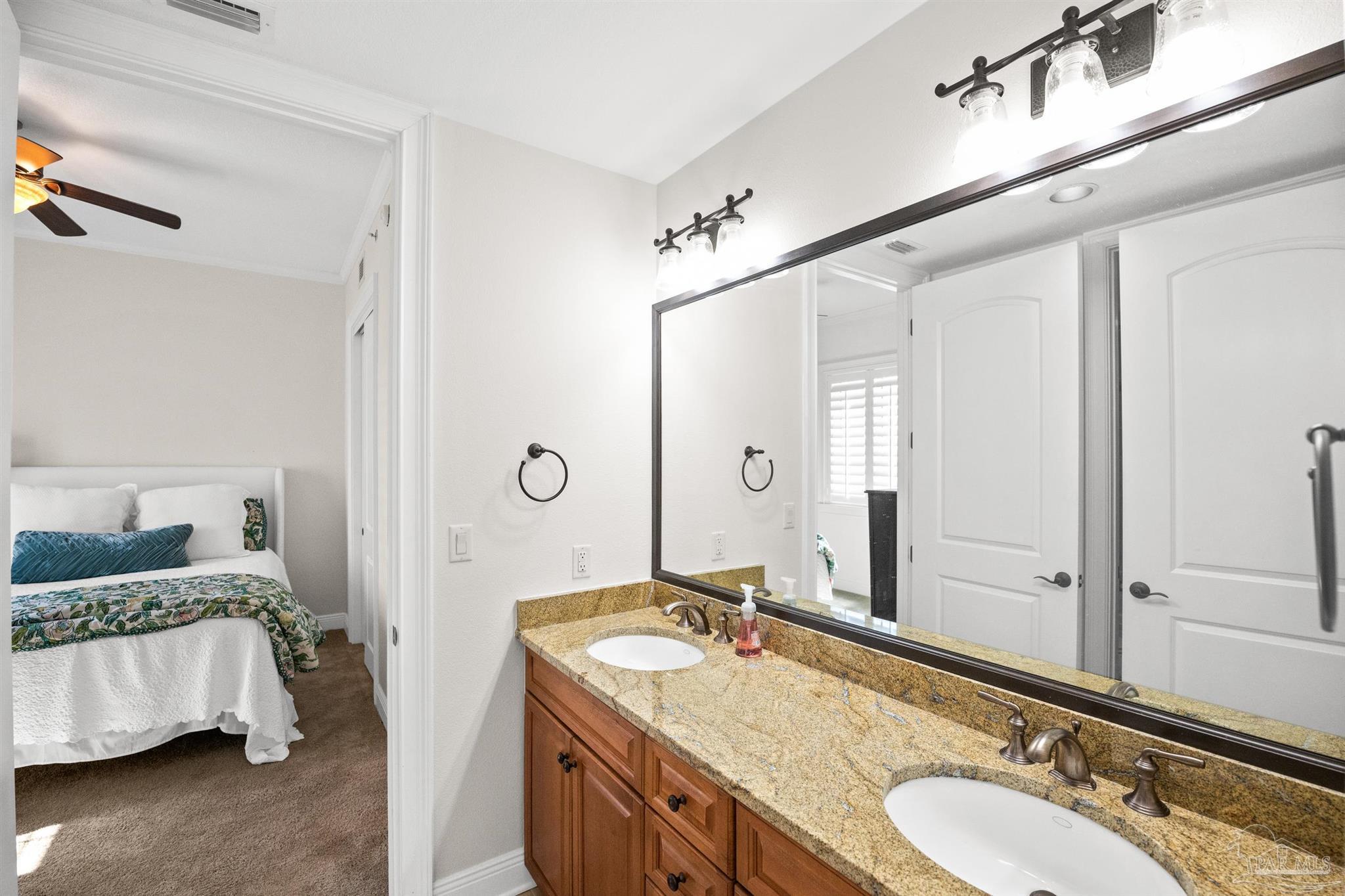 14500 River Road, Unit 101 Pensacola, FL 32507 - Photo 43 of 61 a bathroom with a granite countertop double vanity sink and a mirror