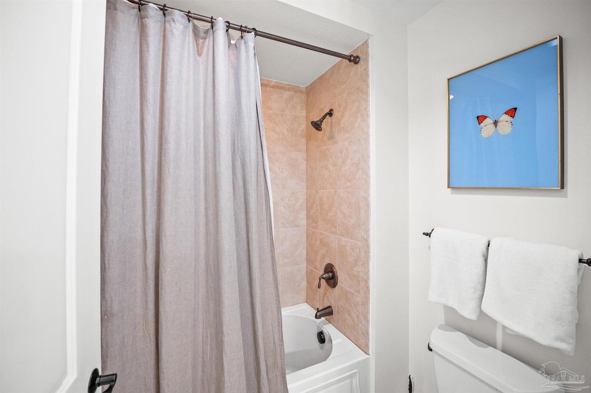 14500 River Road, Unit 101 Pensacola, FL 32507 - Photo 45 of 61 a bathroom with a shower curtain and a sink