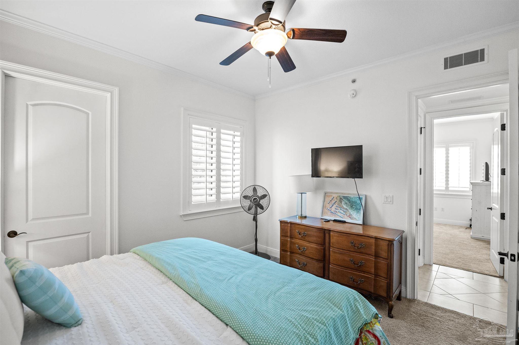 14500 River Road, Unit 101 Pensacola, FL 32507 - Photo 50 of 61 a bedroom with a bed and a flat screen tv