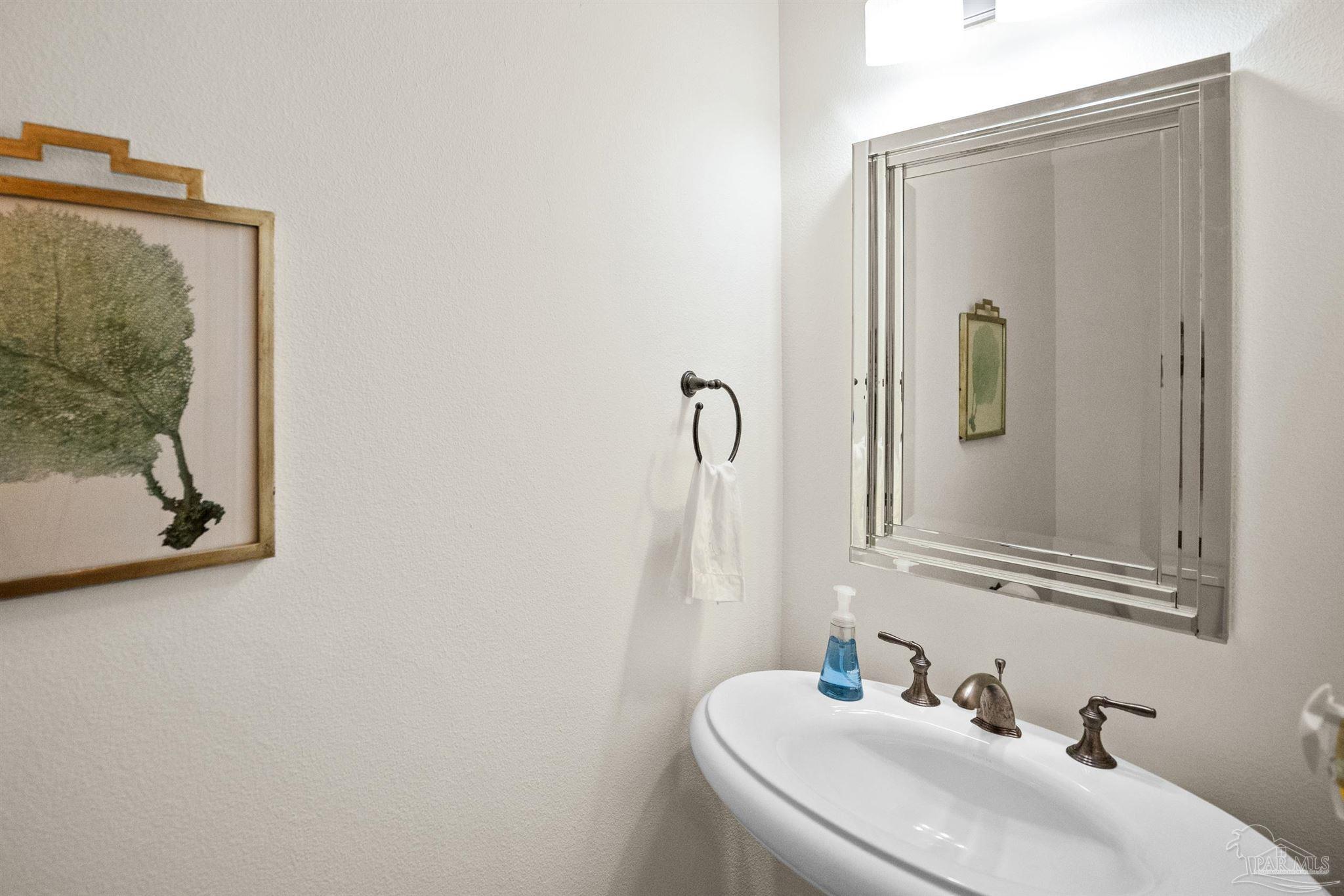 14500 River Road, Unit 101 Pensacola, FL 32507 - Photo 54 of 61 a bathroom with a sink and mirror