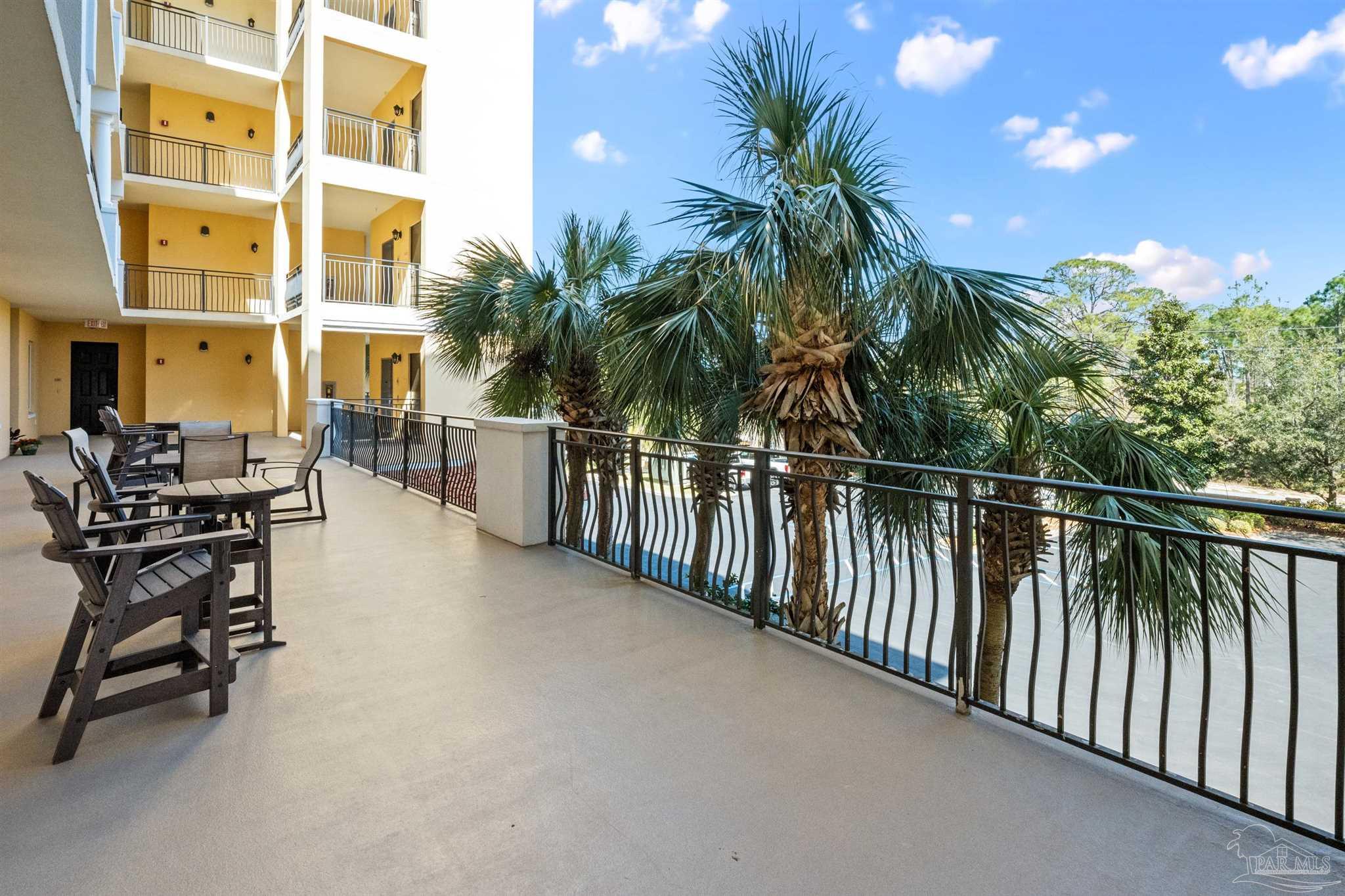 14500 River Road, Unit 101 Pensacola, FL 32507 - Photo 60 of 61 a view of a balcony with potted plants and palm trees