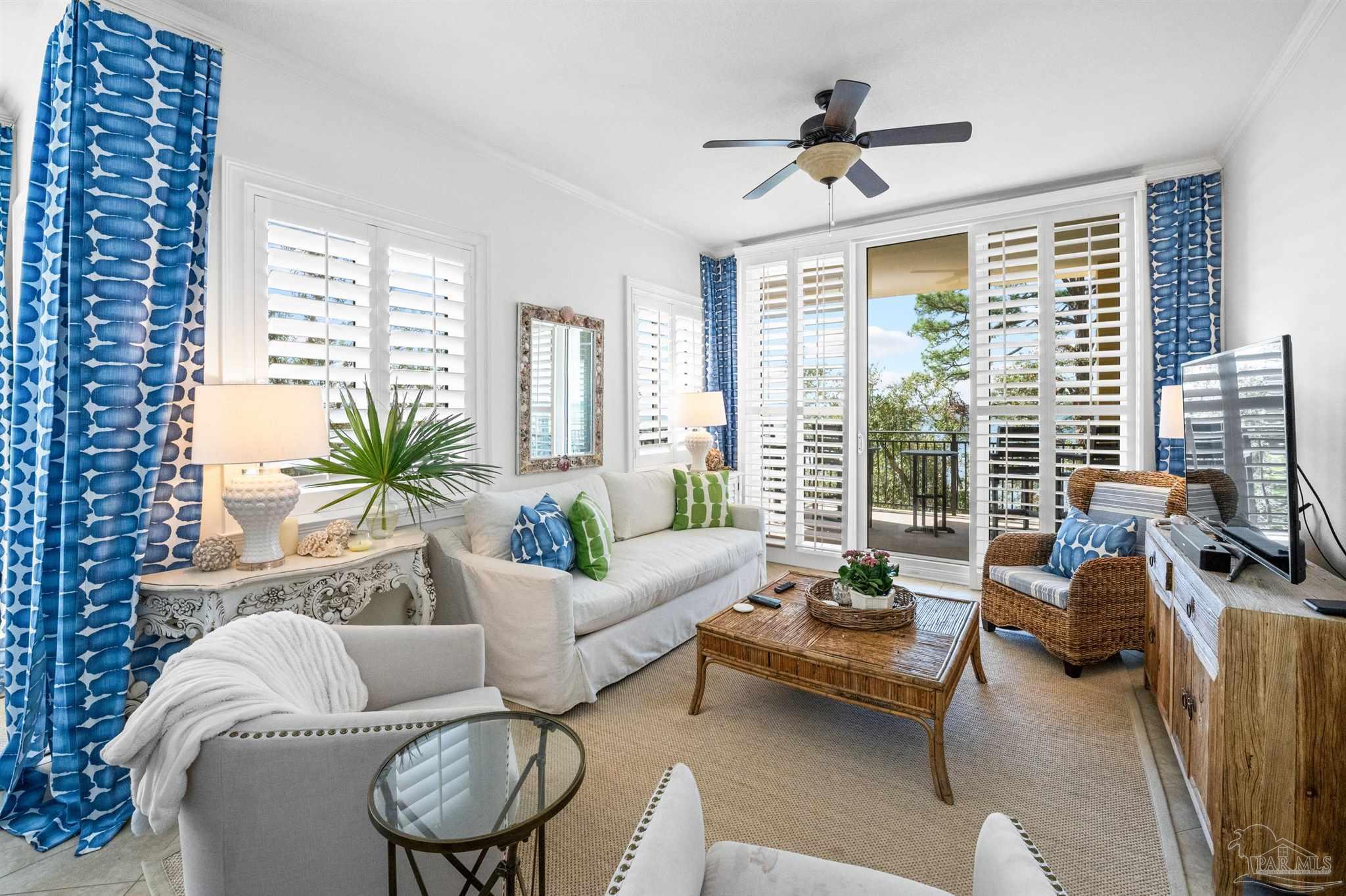14500 River Road, Unit 101 Pensacola, FL 32507 - Photo 10 of 61 a living room with furniture floor to ceiling window and a flat screen tv