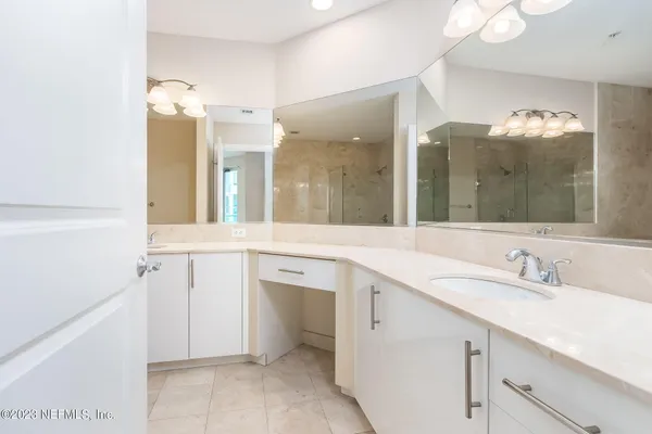 a spacious bathroom with a double vanity sink mirror and