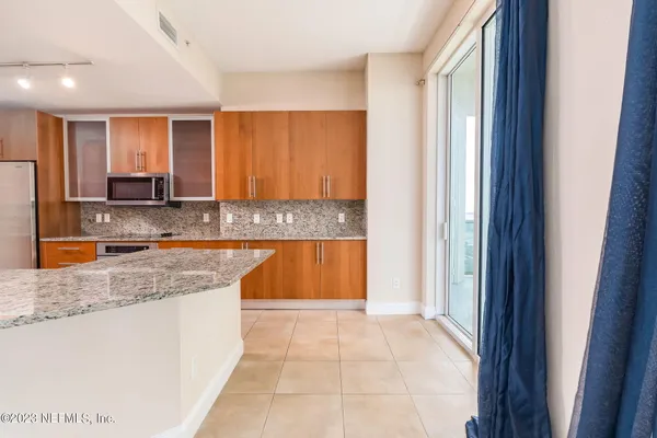 a view of a kitchen with a sink and cabinets